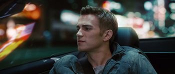 Movie still from “Jumper” (2008), directed by Doug Liman – A man sitting in the back seat of a car; Close Up shot, Over the shoulder angle