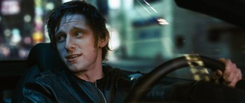 Movie still from “Jumper” (2008), directed by Doug Liman – A man sitting in the drivers seat of a car; Close Up shot, Over the shoulder angle