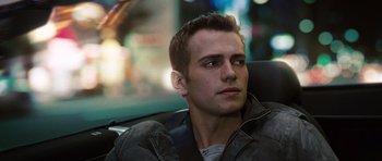 Movie still from “Jumper” (2008), directed by Doug Liman – A man sitting in the back seat of a car; Close Up shot, Over the shoulder angle