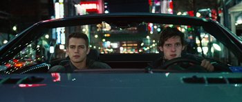 Movie still from “Jumper” (2008), directed by Doug Liman – Two young men sitting in the back seat of a car; Medium shot, Low angle