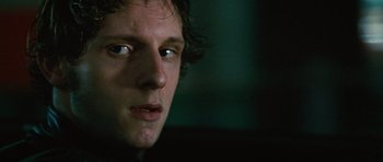 Movie still from “Jumper” (2008), directed by Doug Liman – A man's face in a dark room; Close Up shot, Low angle