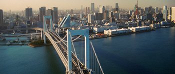 Movie still from “Jumper” (2008), directed by Doug Liman – An aerial view of a bridge and a city skyline; Extreme Wide shot, High angle