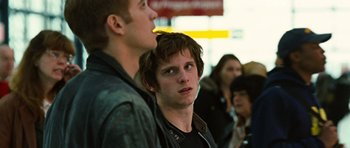 Movie still from “Jumper” (2008), directed by Doug Liman – Two young men standing next to each other in front of a group of onlookers; Close Up shot, Over the shoulder angle
