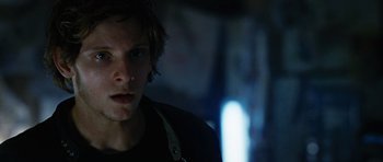 Movie still from “Jumper” (2008), directed by Doug Liman – A young man in a black shirt is looking at the camera; Close Up shot, Low angle