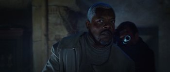 Movie still from “Jumper” (2008), directed by Doug Liman – An older man with a beard is looking at the camera; Close Up shot, Over the shoulder angle