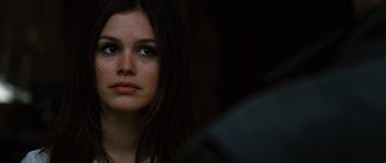 Movie still from “Jumper” (2008), directed by Doug Liman – A woman with a serious look on her face; Close Up shot, Over the shoulder angle