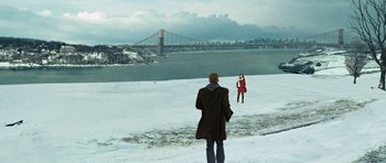 Movie still from “Jumper” (2008), directed by Doug Liman – A man and a woman standing in the snow near a bridge; Extreme Wide shot, High angle