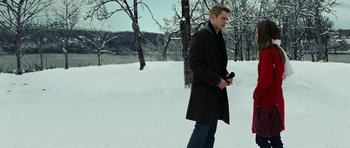 Movie still from “Jumper” (2008), directed by Doug Liman – A man in a black coat is walking in the snow; Wide shot, Low angle