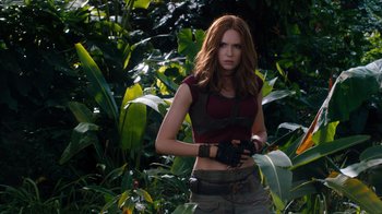 Movie still from “Jumanji: Welcome to the Jungle” (2017), directed by Jake Kasdan – A woman standing in the middle of a forest; Medium shot, Low angle