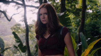 Movie still from “Jumanji: Welcome to the Jungle” (2017), directed by Jake Kasdan – A woman with long brown hair wearing a red shirt; Medium shot, Low angle