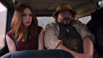 Movie still from “Jumanji: Welcome to the Jungle” (2017), directed by Jake Kasdan – A man and a woman sitting in the back of a car; Medium shot, Over the shoulder angle
