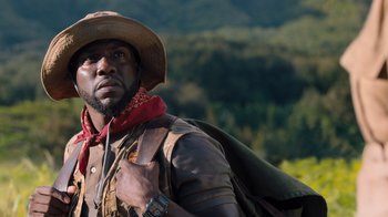 Movie still from “Jumanji: Welcome to the Jungle” (2017), directed by Jake Kasdan – A man with a cowboy hat and a backpack; Close Up shot, Low angle