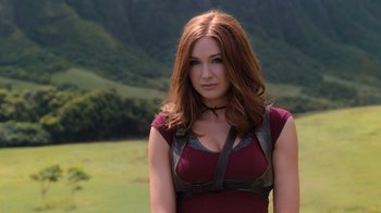 Movie still from “Jumanji: Welcome to the Jungle” (2017), directed by Jake Kasdan – A beautiful woman with long red hair wearing a red dress; Close Up shot, Low angle