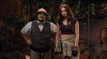 Movie still from “Jumanji: Welcome to the Jungle” (2017), directed by Jake Kasdan – A man standing next to a beautiful woman; Medium shot, Low angle