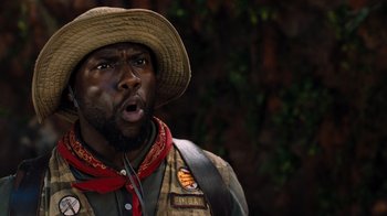 Movie still from “Jumanji: Welcome to the Jungle” (2017), directed by Jake Kasdan – A person wearing a hat; Close Up shot, Over the shoulder angle