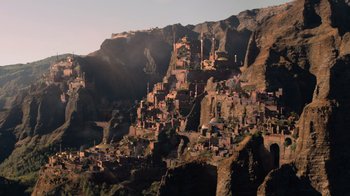 Movie still from “Jumanji: Welcome to the Jungle” (2017), directed by Jake Kasdan – A view of a small town on the side of a mountain; Extreme Wide shot, High angle