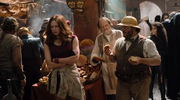 Movie still from “Jumanji: Welcome to the Jungle” (2017), directed by Jake Kasdan – A group of people standing around a market; Medium shot, Over the shoulder angle