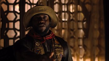 Movie still from “Jumanji: Welcome to the Jungle” (2017), directed by Jake Kasdan – A man wearing a straw hat and a vest; Close Up shot, Low angle