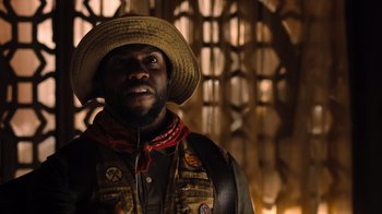 Movie still from “Jumanji: Welcome to the Jungle” (2017), directed by Jake Kasdan – A man wearing a straw hat and a vest; Close Up shot, Low angle
