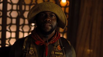 Movie still from “Jumanji: Welcome to the Jungle” (2017), directed by Jake Kasdan – A man wearing a cowboy hat and a vest; Close Up shot, Low angle