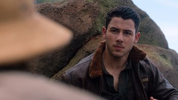Movie still from “Jumanji: Welcome to the Jungle” (2017), directed by Jake Kasdan – A person wearing a leather jacket; Close Up shot, Over the shoulder angle