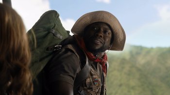 Movie still from “Jumanji: Welcome to the Jungle” (2017), directed by Jake Kasdan – A man with a hat and a backpack; Close Up shot, Low angle