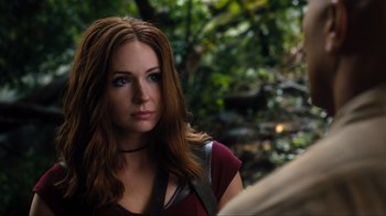 Movie still from “Jumanji: Welcome to the Jungle” (2017), directed by Jake Kasdan – A woman with long brown hair wearing a red shirt; Close Up shot, Over the shoulder angle