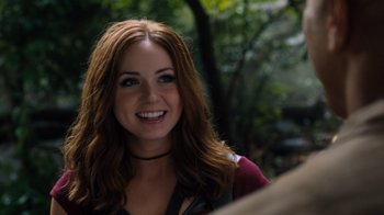 Movie still from “Jumanji: Welcome to the Jungle” (2017), directed by Jake Kasdan – A beautiful young lady smiling for the camera; Close Up shot, Over the shoulder angle