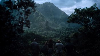 Movie still from “Jumanji: Welcome to the Jungle” (2017), directed by Jake Kasdan – A group of people standing on top of a lush green hill; Extreme Wide shot, High angle