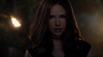 Movie still from “Jumanji: Welcome to the Jungle” (2017), directed by Jake Kasdan – A beautiful woman with long brown hair wearing a black shirt; Close Up shot, Over the shoulder angle
