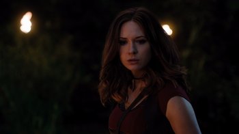 Movie still from “Jumanji: Welcome to the Jungle” (2017), directed by Jake Kasdan – A beautiful woman with long brown hair standing in the dark; Close Up shot, Over the shoulder angle