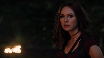 Movie still from “Jumanji: Welcome to the Jungle” (2017), directed by Jake Kasdan – A beautiful woman with long brown hair wearing a red shirt; Close Up shot, Over the shoulder angle