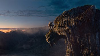 Movie still from “Jumanji: Welcome to the Jungle” (2017), directed by Jake Kasdan – A man is climbing a rock formation on a cliff; Extreme Wide shot, Low angle