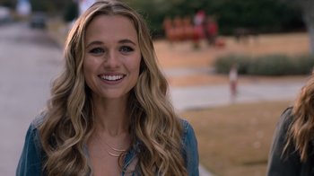 Movie still from “Jumanji: Welcome to the Jungle” (2017), directed by Jake Kasdan – A beautiful young lady smiling for the camera; Close Up shot, Over the shoulder angle