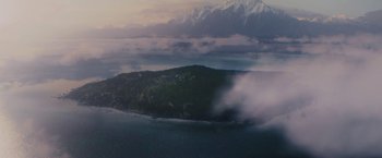 Movie still from “Jungle” (2017), directed by Greg McLean – An aerial view of a small island in the middle of the ocean; Extreme Wide shot, High angle