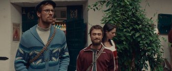 Movie still from “Jungle” (2017), directed by Greg McLean – A group of people standing next to each other in front of a building; Medium shot, Over the shoulder angle