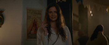 Movie still from “Jungle” (2017), directed by Greg McLean – A woman is smoking a cigarette in a room; Close Up shot, Over the shoulder angle