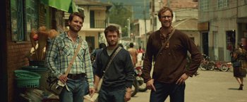 Movie still from “Jungle” (2017), directed by Greg McLean – A group of men walking down a street; Medium shot, Low angle