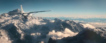 Movie still from “Jungle” (2017), directed by Greg McLean – A view from an airplane of the sky and mountains; Extreme Wide shot, High angle