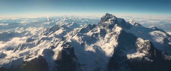 Movie still from “Jungle” (2017), directed by Greg McLean – A view of a mountain range from a plane window; Extreme Wide shot, High angle