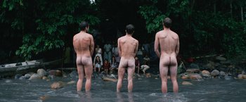 Movie still from “Jungle” (2017), directed by Greg McLean – A group of naked men standing in a body of water; Wide shot, High angle