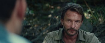 Movie still from “Jungle” (2017), directed by Greg McLean – A person wearing a jacket; Close Up shot, Over the shoulder angle
