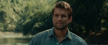 Movie still from “Jungle” (2017), directed by Greg McLean – A person wearing a blue shirt; Close Up shot, Over the shoulder angle