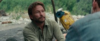 Movie still from “Jungle” (2017), directed by Greg McLean – A person sitting on a chair; Close Up shot, Over the shoulder angle