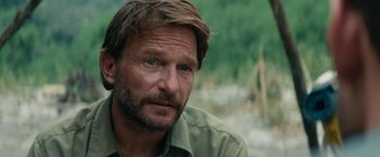 Movie still from “Jungle” (2017), directed by Greg McLean – A person wearing a shirt; Close Up shot, Over the shoulder angle