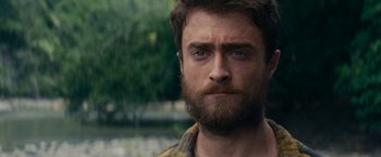 Movie still from “Jungle” (2017), directed by Greg McLean – A person with a beard; Close Up shot, Over the shoulder angle