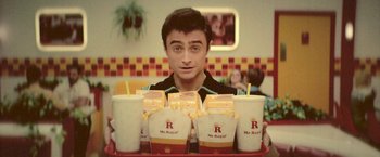 Movie still from “Jungle” (2017), directed by Greg McLean – A man sitting in front of a tray of food; Close Up shot, Overhead angle