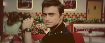 Movie still from “Jungle” (2017), directed by Greg McLean – A person holding a piece of food; Close Up shot, Over the shoulder angle