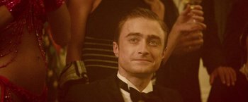 Movie still from “Jungle” (2017), directed by Greg McLean – A person wearing a suit and bow tie; Close Up shot, Over the shoulder angle