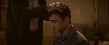 Movie still from “Jungle” (2017), directed by Greg McLean – A man getting his hair combed by another man; Close Up shot, High angle